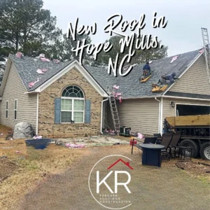 New roof installation on a house in Hope Mills, NC, with workers on the roof.